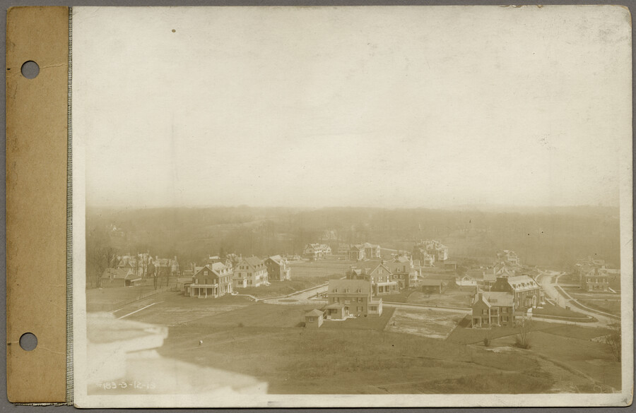 Aerial view from the summit of 4210 Roland Avenue – the Roland Water Tower – looking east at houses in the Roland Park neighborhood of Baltimore, Maryland. Curving thoroughfare at extreme right is western end of Overhill Road.