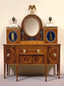 Mahogany, satinwood, red cedar, and glass Lady's Cabinet Dressing Table, 1800-1810, attributed to Baltimore cabinet maker William Camp (1733-1822). This dressing table, one of the finest pieces of American furniture, demonstrates the outstanding sophistication and skill of Baltimore cabinetmakers in the early-1800s. Although inspired by an English design source, the cabinetmaker adapted it to suit…