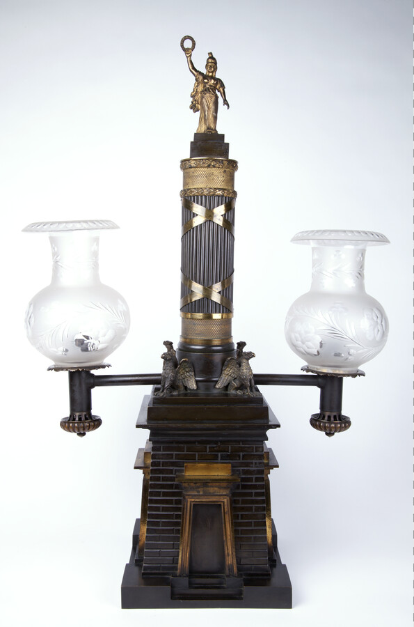 Metal and glass oil Argand lamp, ca. 1825, featuring two globes, a replica of Baltimore's Battle Monument, four griffins, and a laurel wreath on top, by an unknown British artist. This realistic representation of the Battle Monument was made as an Argand lamp in England exclusively for the Baltimore market. Within months of the Treaty…