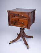 Work or sewing table labeled by Baltimore furniture maker John Needles (1786-1868). It features two drawers atop four curved and reeded legs on brass eagle casters.