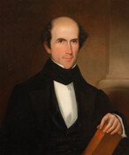 Bust-length portrait of Benjamin Gwinn Harris (1806-1895) by George Cooke (1793-1849). Harris is pictured as a man with brown hair and receding hairline. He wears a black coat, stock, and vest with a white shirt. He holds a book in his left hand.