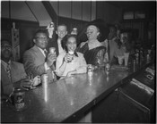Group of patrons posing for a promotional photograph for Hals Beer at an unidentified bar.