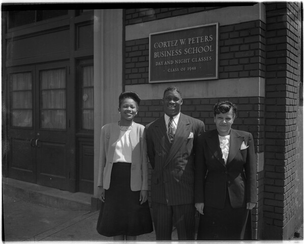 Three people in front of Cortez W. Peters Business School — circa 1949-05