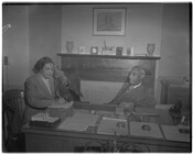 Dr. Elmer A. Henderson in a meeting with an unidentified woman at his office within the administration building located behind Booker T. Washington High School. Henderson was Director of Colored Schools before he was appointed Assistant Superintendent in 1945 and served on the Board of Superintendents to help create policy and administer the public schools…
