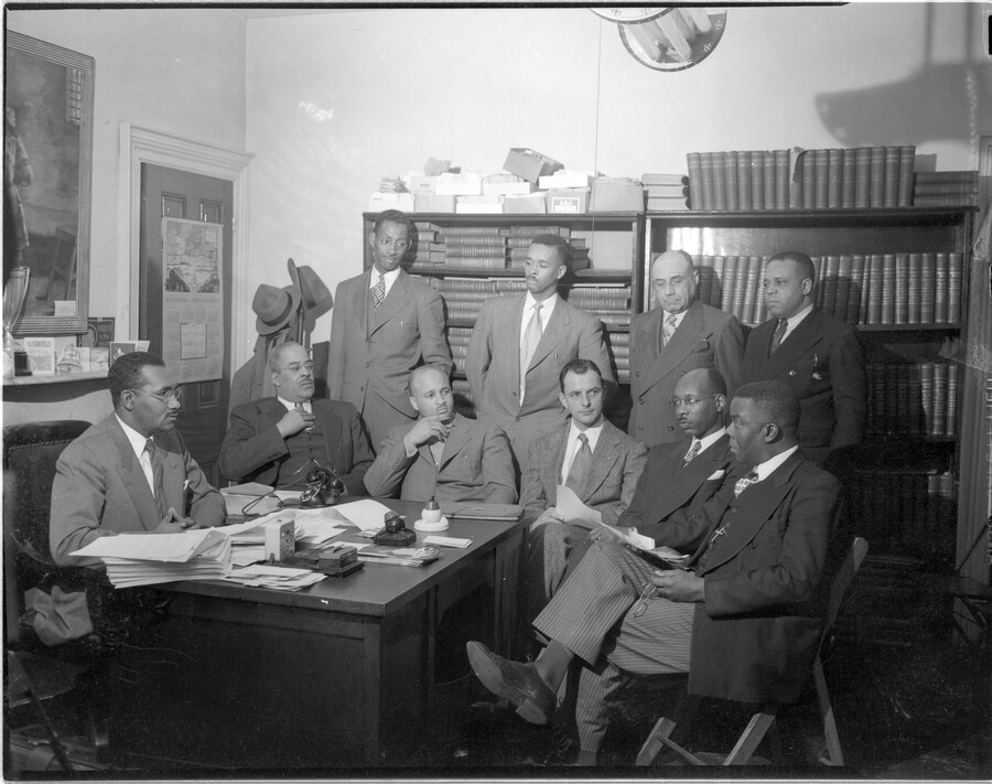 A meeting of the Labor Committee members of the NAACP. Seated from left: Clarence M. Mitchell, Jr., national NAACP labor secretary; Cecil Scott; C. M. Puryear; D. R. Page; Reverend Thomas Davis; Reverend Harrison Bryant. Standing from left: Reverend Eugene T. Grove; Emerson Brown, Jr.; J. Alvin Jones; and Raymond A. C. Young.