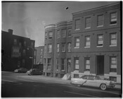Street view of row homes on McCulloh Street and Bloom Street in Baltimore, Maryland.