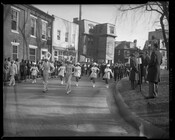 A marching band, possibly from Morgan State College, marching down a street in Annapolis, Maryland, during the inauguration of Governor Theodore McKeldin.