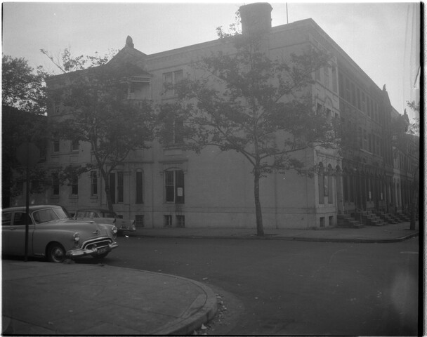 Row houses and cars at street corner — 1959-10