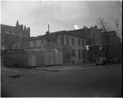 Street view of garages, row houses, and automobiles on an unidentified street in Baltimore, Maryland.