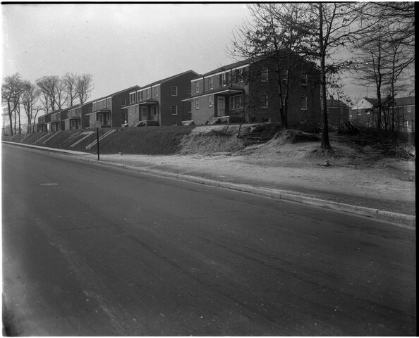 Street view of a housing development — circa 1954-02