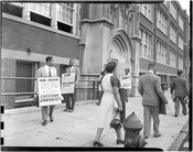 Protestors, including Parren J. Mitchell (far left) and Dr. John E.T. Camper (second from left), outside of Douglass High School in Baltimore, Maryland, marching to protest the segregation of teacher training programs.