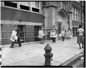 Street scene of a demonstration to protest segregated education and teacher training programs at Douglass High School, located at 700-702 Baker Street in Baltimore, Maryland.