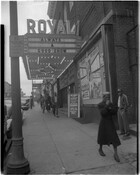 Exterior view of the Royal Theatre. The venue was located at 1329 Pennsylvania Avenue in Baltimore, Maryland. Several pedestrians are walking in front of the theatre.