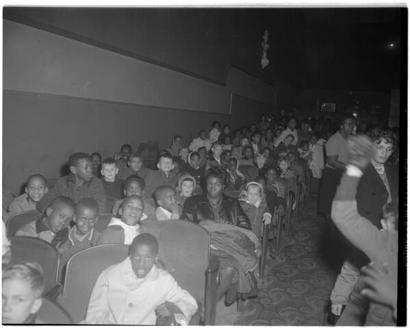 People sitting inside theater — circa 1962