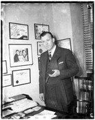 Portrait of Maryland Governor Theodore McKeldin (1900-1974). McKeldin is standing in front of a desk and holding a pocket watch. In addition to serving as governor of Maryland (1951-1959), McKeldin served two terms as mayor of Baltimore (1943-1947, 1963-1967).