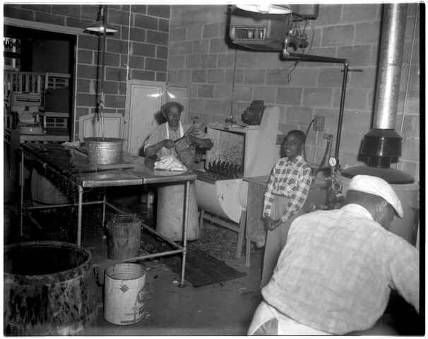 People inside the kitchen of a delicatessen or restaurant — 1953-10