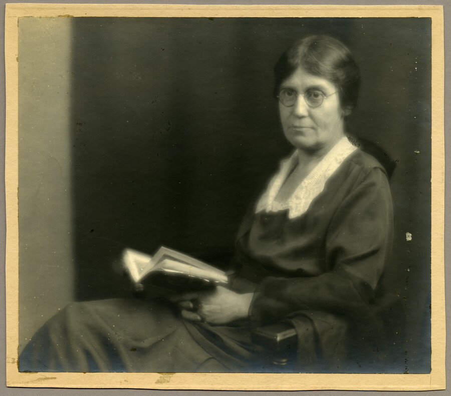 Undated portrait of Baltimore, Maryland, photographer Emily Spencer Hayden, seated and holding an open book.