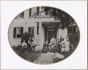 Portrait of the Farnandis family in front of their estate. Identification of each member of the family in the photo can be found on the verso.