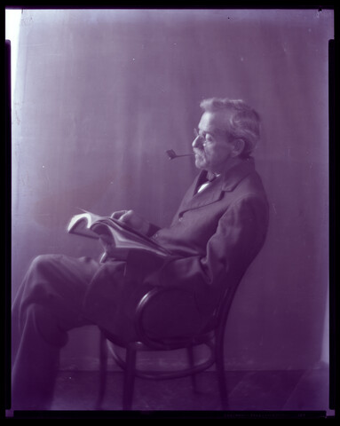Portrait of Charles S. Hayden reading with pipe — circa 1935