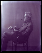 Undated portrait of Charles S. Hayden, husband of Baltimore, Maryland, photographer Emily Spencer Hayden, seated with a pipe in his mouth and holding an open book.