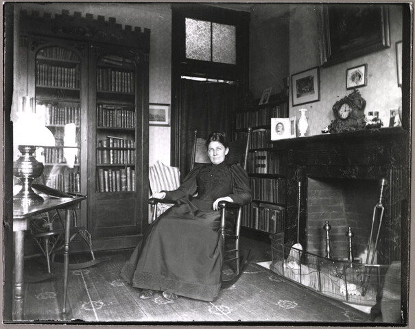 Unidentified woman in living room of 123 W Lanvale St. — 1895