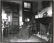 An unidentified woman (possibly Mary E. Steuart) seated in a rocking chair. Taken in the living room of the Steuart family home at 123 W Lanvale St., Baltimore, Maryland.