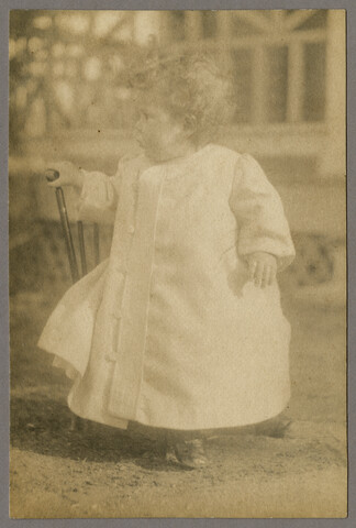 Portrait of young Ruth Hayden (Wanzer) holding a chair — circa 1897