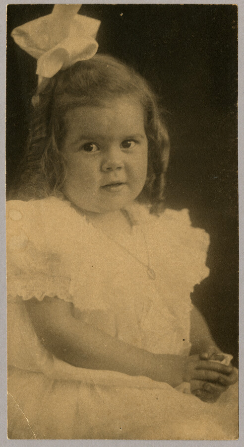 Undated portrait of Baltimore, Maryland, photographer Emily Spencer Hayden's daughter Ruth wearing a dress, necklace, and bow in her hair. Verso transcription: Ruth Hayden