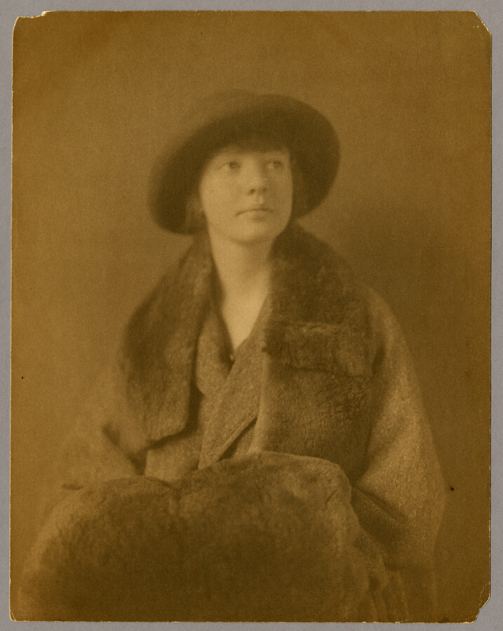 Portrait of Ruth Hayden (Wanzer), daughter of Baltimore, Maryland, photographer Emily Spencer Hayden, wearing a hat, fur trimmed coat, and fur muff.