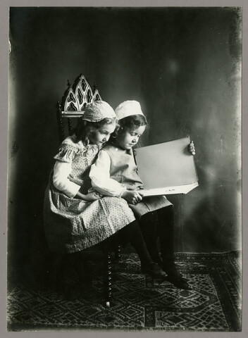 Portrait of Ruth Hayden and friend reading a book — circa 1900