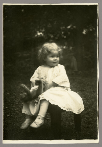 Portrait of Anna Bradford Hayden seated outside with teddy bear — circa 1905