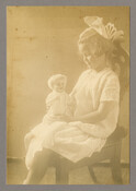 Portrait of Baltimore, Maryland, photographer Emily Spencer Hayden's daughter Anna Bradford Hayden, also known as "Nan," seated on a wooden chair and holding a doll.