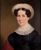 Half-length portrait of Catherine Bose Dobbin (1786-1875) Her curled brown hair is tucked underneath a white turban. She wears a lace collar and a thin gold chain over a black dress with gigot sleeves. She carries a red patterned shawl on her shoulder. She married George Dobbin (1774-1811) of Ireland in Baltimore on September 15,…