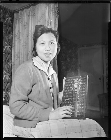 Portrait of Tuey M. Hom with abacus — 1958-03