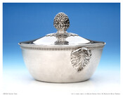 Silver covered vegetable tureen with three-dimensional textured finial on lid and eagle's head handles on base.
