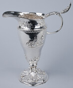 Ornate silver creamer pitcher. Made in Baltimore, Maryland by Samuel Kirk & Son.