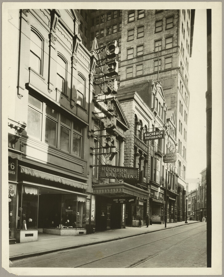 View of West Lexington Street in Baltimore, Maryland, between Charles Street and Cathedral Street, showing Loew's Century Theatre at 18 West Lexington Street, Bachrach Photographers, and Huyler's Restaurant. In 1962 the block was razed to make way for the Charles Center. John J. Zink (1886-1952) designed the theater, which opened on May 7, 1921.