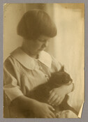 Portrait of a young girl holding a cat in her lap. The child was not identified by the photographer Emily Spencer Hayden of Baltimore, Maryland.