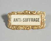 "Anti-Suffrage" printed on paper with ornate metal frame. Anti-suffrage groups emerged in the late 19th century in response to the formation of pro-suffrage organizations in the country and in the state of Maryland. This badge may have been produced for use by the Maryland Association Opposed to Woman Suffrage (1911-1922).