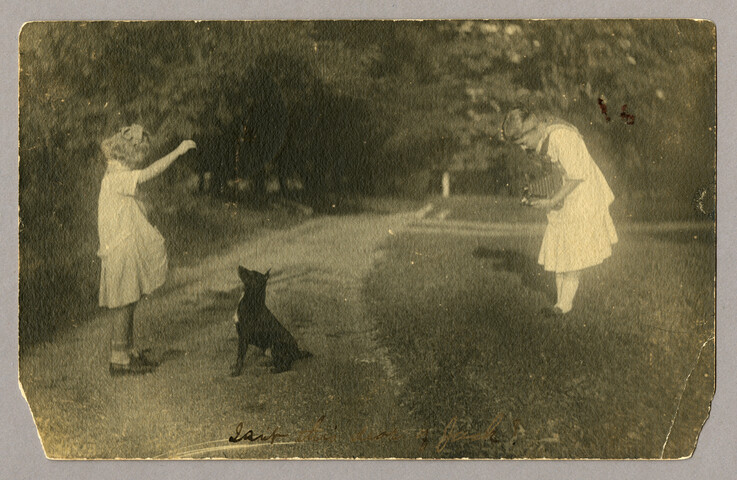 Two girls with a camera and dog — undated