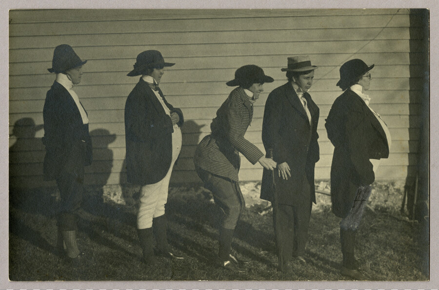 Outdoor portrait of five unidentified women in men's dress.