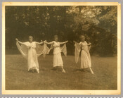 Three dancers from Goucher College performing “Cupid and Psyche," from a series of photographs by the Baltimore, Maryland, photographer Emily Spencer Hayden. A note on back of one of the photographs states that the women’s performance stopped traffic on Edmondson Avenue. The students were likely part of a group called the “Dickens Club.”