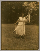 A dancer from Goucher College performing "Cupid and Psyche" from a series of photographs by the Baltimore, Maryland, photographer Emily Spencer Hayden. A note on back of one of the photographs states that the women’s performance stopped traffic on Edmondson Avenue. The students were probably part of a group called the “Dickens Club.”