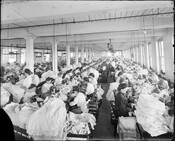 Interior view of the Oppenheim-Obendorf & Company shirt factory at 112-114 West Fayette Street in Baltimore, Maryland. The image shows seamstresses at work, along with supervisors.