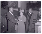 Civil rights activist Lillie May Carroll Jackson standing in what appears to be a church with Bishop Harrison Bryant (right) and receiving an award from an unidentified person (left).