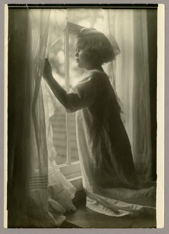 Portrait of Anna ‘Nan’ Bradford Hayden (Agle) kneeling at the window — undated