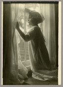 Anna "Nan" Bradford Hayden (Agle), the daughter of Baltimore, Maryland, photographer Emily Spencer Hayden, is kneeling and looking through the curtains at the window. Verso transcription: Anna Bradford Hayden. The Christmas Star