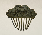 Gold-plated silver hair comb that features ogee curves and a cartouche that depicts a village scene. "E.C.R." is engraved on the comb.