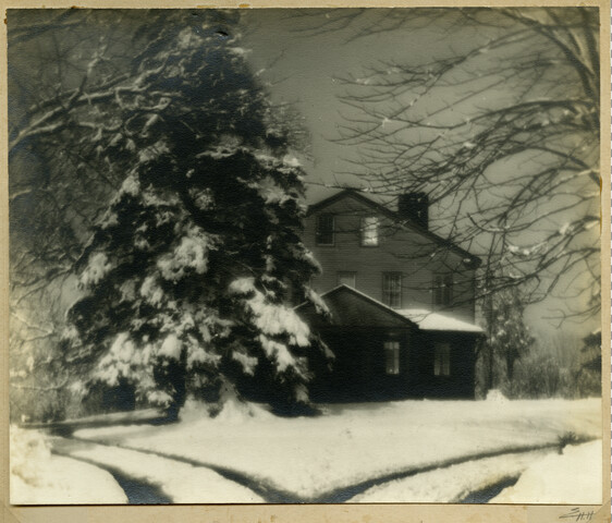 House and evergreen covered in snow — circa 1915
