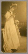 A woman and child reading a small book, possibly in prayer. Part of a series of portraits by the Baltimore, Maryland, photographer Emily Spencer Hayden.